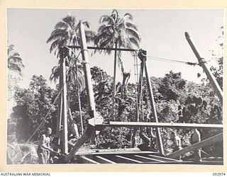 BOUGAINVILLE. 1945-05-31. SAPPERS OF 5 FIELD COMPANY, ROYAL AUSTRALIAN ENGINEERS, ASSEMBLING A GENERAL STEEL BRIDGE OVER THE SWAMP BEACH ROAD BETWEEN MOTUPENA POINT AND TOKO, THE MAIN SUPPLY ROUTE ..