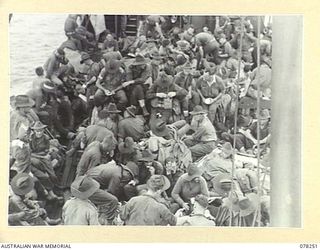 SIPAAI, BOUGAINVILLE ISLAND. 1945-01-07. TROOPS OF THE 31/51ST INFANTRY BATTALION ENJOYING THEIR BREAKFAST ABOARD THE AV1361 "POOLTA" AS SHE APPROACHES THE MOUTH OF THE KAIKARA RIVER WHERE THE UNIT ..