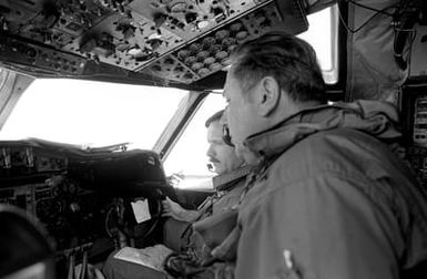 The pilot and co-pilot of a P-3 Orion aircraft of Naval Air Reserve Patrol Squadron 64 (VP-64) monitor their instrument panel during active duty training