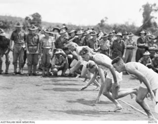 DONADABU, PAPUA, NEW GUINEA. 1944-01-01. COMPETITORS SPRING OFF THE MARK AT THE START OF THE 440 YARDS RACE DURING THE 15TH INFANTRY BRIGADE GYMKHANA. IDENTIFIED PERSONNEL ARE: PRIVATE MANAGER (1); ..