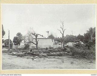 PARTLY DEMOLISHED BUILDINGS AT SAMARAI ISLAND DESTROYED BY AUSTRALIAN MILITARY FORCES BEFORE EVACUATING THE ISLAND, WHICH IS SMALL AND OF LITTLE MILITARY VALUE