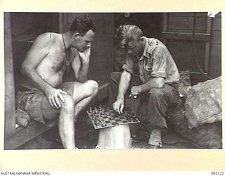 AT SEA. 1944-10-27. CORPORAL N. LOCKYER, 101 FIELD SECURITY SECTION (1), WITH CPL G. BRYCE, FIRST ARMY AIR PHOTO INTERPRETATION UNIT (2), PLAYING CHESS ABOARD SS JAMES OLIVER DURING THEIR MOVEMENT ..