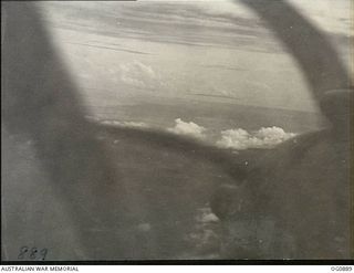 BISMARCK ARCHIPELAGO. 1944-03-28. PART OF NEW BRITAIN SEEN FROM A BEAUFIGHTER AIRCRAFT OF NO. 30 SQUADRON RAAF FLOWN BY FLIGHT SERGEANT T. BOEHM OF SA, AS ESCORT AIRCRAFT, OF NO. 79 (SPITFIRE) ..