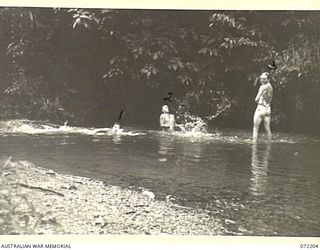 NEW GUINEA. 1944-04-04. SIGNAL PERSONNEL FROM THE CAMP NAURO SIGNAL STATION, 23RD LINE SECTION, 18TH LINES OF COMMUNICATION SIGNALS, BATHING IN THEIR CAMP POOL