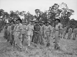 LAE AREA, NEW GUINEA, 1945-06-16. LT-GEN V.A.H. STURDEE, GOC FIRST ARMY (1) AND MAJ J.H.W. STAFFORD, OFFICER COMMANDING 2 A TROOPS COMPANY (AIF) (2), INSPECTING TROOPS OF THE UNIT DURING A PARADE ..