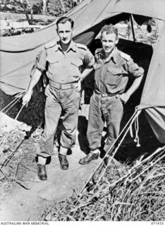 FINSCHHAFEN AREA, NEW GUINEA, 1944-03-21. VX48010 CAPTAIN J. SUMMERTON (1) WITH NX322 LIEUTENANT COLONEL F.G. HASSETT (2), AT ADVANCED HEADQUARTERS, 2ND AUSTRALIAN CORPS