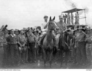 SOPUTA, NEW GUINEA. 1943-10-09. "PADRE BILL" WITH GUNNER GATCHELL UP (LEFT) - WINNER OF THE SOPUTA CUP, POSES FOR THE CAMERA AT THE RACE MEETING CONDUCTED BY THE 11TH AUSTRALIAN DIVISION