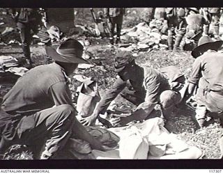 NAURU ISLAND. 1945-09-16. JAPANESE POWS UNDERGOING A KIT INSPECTION PRIOR TO THEIR EVACUATION TO BOUGAINVILLE SOON AFTER TROOPS OF THE 31/51ST INFANTRY BATTALION TOOK OVER THE ISLAND