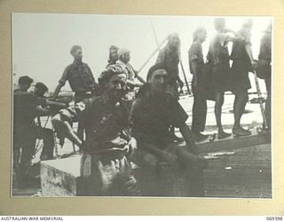 PORT MORESBY, NEW GUINEA. 1942-04-12. VX44355 LIEUTENANT J.D. UZZELL (FOREGROUND) OF THE 2/22ND INFANTRY BATTALION AND OTHER SERVICE PERSONNEL ABOUT TO BOARD THE MV "MACDHUI", WHICH IS TO TAKE THEM ..