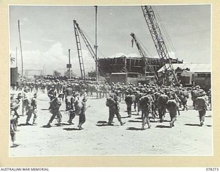 TOROKINA, BOUGAINVILLE ISLAND. 1945-01-02. TROOPS OF THE 24TH INFANTRY BATTALION, FALLING IN AFTER DISEMBARKING FROM AN LANDING CRAFT TROOPS. THEY ARE NOW TO EMBUSS FOR THE LAST STAGE OF THEIR ..