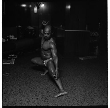 Men at a bodybuilding competition, posing on stage and backstage at an undentified venue in Porirua