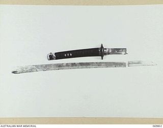 CANBERRA, ACT. 1957-05-03. A BROKEN JAPANESE SWORD CAPTURED DURING AN ACTION AT MAROVA, NEW GEORGIA, BY MAJOR D.G. KENNEDY, DSO. MAJOR KENNEDY WAS AN OUTSTANDING PERSONALITY AMONG THE COASTWATCHERS ..