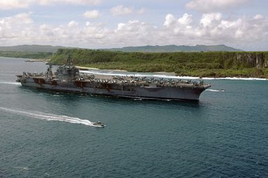 The US Navy (USN) Aircraft Carrier USS KITTTY HAWK (CV-63) departs Naval Forces Marianas Support Activity, Guam, after a four-day port visit. Currently under way in the 7th Fleet area of responsibility (AOR), the KITTY HAWK demonstrates power projection and sea control as the US Navy's only permanently forward-deployed aircraft carrier