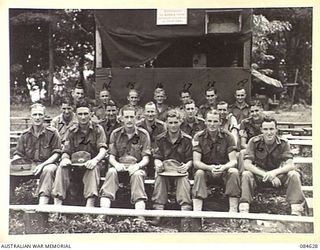 GREEN ISLAND, BOUGAINVILLE AREA, SOLOMON ISLANDS. 1944-12-19. HQ 23 INFANTRY BRIGADE NCOS IN THE PICTURE ARENA. THE NOTICE ON THE PROJECTION BOX AT THE BACKGROUND DISALLOWING BEER AND COKE BOTTLES ..