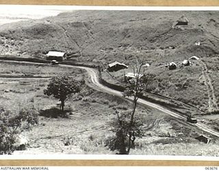 "THE SADDLE", SHAGGY RIDGE, NEW GUINEA. 1944-01-10. A VIEW FROM B ECHELON, 2/9TH INFANTRY BATTALION SHOWING THE ROAD TO THE 18TH INFANTRY BRIGADE HEADQUARTERS