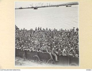 WEWAK HARBOUR, NEW GUINEA. 1945-09-03. BARGES CONTAINING AUSTRALIAN TROOPS COMING ALONGSIDE THE TROOPSHIP, SS RIVER FITZROY. THIS IS THE FIRST TIME AN AUSTRALIAN FREIGHTER HAS BEEN CONVERTED INTO A ..