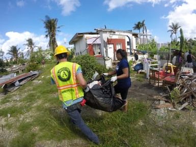 AmeriCorps Disaster response Team member Teddy Lasky, with community volunteer Karen Layoan assisting at a home site in As Matuis.