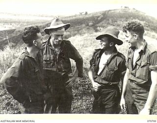 RAMU VALLEY, NEW GUINEA, 1944-02-29. MEMBERS OF NO.16 AND NO.17 PLATOONS "D" COMPANY, 2/12TH INFANTRY BATTALION REVIVE MEMORIES OF THE PROTHERO FEATURES. IDENTIFIED PERSONNEL ARE: QX19187 SERGEANT ..