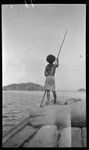 Man poles canoe, near Port Moresby