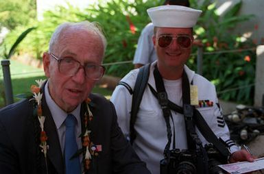 Author James Michener poses for a photograph with Fleet Imaging Command, Pacific member PH1 Bob Wilson. Michener is attending an observance commemorating the 50th anniversary of the Japanese attack on Pearl Harbor