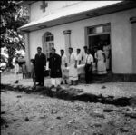 Coffin being carried out side south door of LMS church