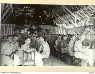 LAE BASE AREA, NEW GUINEA. 1944-12-24. NON COMMISSIONED OFFICERS OF HEADQUARTERS, FIRST AUSTRALIAN ARMY AT LUNCH IN THE SERGEANTS' MESS