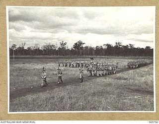 WONDECLA, QLD. 1944-04-15. A COMPANY OF THE 2/1ST INFANTRY BATTALION GIVE "EYES RIGHT" AS THEY MARCH PAST THEIR COMMANDING OFFICER, NX163 LIEUTENANT COLONEL P.A. CULLEN, DSO. (4), WITH THE ..