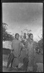 Portrait of two young women holding umbrellas