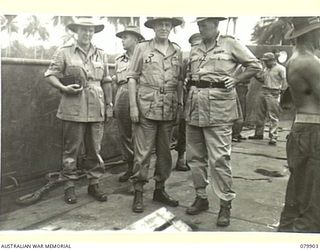 AITAPE, NEW GUINEA. 1945-03-23. LORD WAKEHURST, KCMG, GOVERNOR OF NEW SOUTH WALES (3) ABOARD AN AMERICAN LCT (LANDING CRAFT TANK), FERRYING SUPPLIES FROM SHIPS ANCHORED OFF-SHORE, WATCHES ..