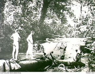THE SOLOMON ISLANDS, 1945-01-12. AIF PERSONNEL RELAXING IN AND BY A RIVER. (RNZAF OFFICIAL PHOTOGRAPH.)