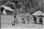 People cut grass around government rest house in Tsembaga, anticipating visit of patrol officer