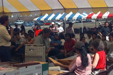 Head of households are called up to receive room assignments at the temporary housing in converted dorms at Andersen Air Force Base south, Guam, after Super Typhoon Paka