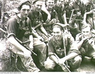 THE SOLOMON ISLANDS, 1945-03-27. A GROUP OF AUSTRALIAN SERVICEMEN RESTING BESIDE THE NUMA NUMA TRAIL ON BOUGAINVILLE ISLAND. (RNZAF OFFICIAL PHOTOGRAPH.)