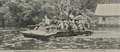 Infantrymen in a tracked amphibious vehicle patrol the shores of Sentani Lake near Hollandia, Dutch New Guinea