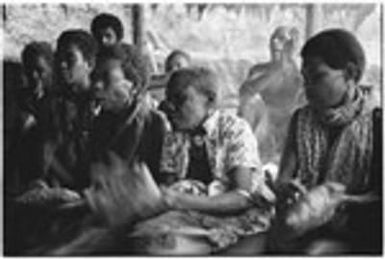 Women beating leaf packets in accompaniment of 'aubinubinu panpiping; woman at far left foreground is 'Osiabu