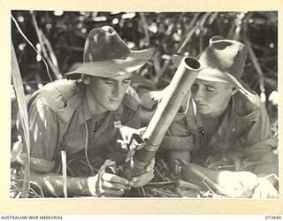 ALEXISHAFEN, NEW GUINEA. 1944-05-17. Q270994 PRIVATE V.C. STEGER (1), AND S110703 PRIVATE F.H. MAIDEN (2), 35TH INFANTRY BATTALION, PREPARE A 2 INCH MORTAR FOR THE SHELLING OF POSSIBLE JAPANESE ..