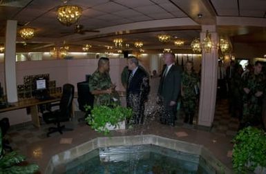 U.S. Air Force MAJ. Anthony Lanuzo (foreground left), Commander, 36th Services Squadron briefs U.S. Secretary of Defense The Honorable Donald H. Rumsfeld, on the features of the Magellan Inn Dining facility during a visit to Andersen Air Force Base, Guam, Nov. 14, 2003. (DoD photo by SENIOR AIRMAN Joshua Strang) (Released)