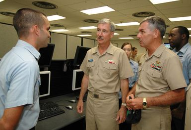 060815-N-4965F-003 (Aug. 15, 2006)US Navy (USN) Rear Adm. T. G. Alexander (left), Commander, Navy Region Hawaii, speaks with USN Information Systems Technician 1ST Class (IT1) Kevin Armendariz, a Pacific Regional Network Operation Center leading CHIEF PETTY Officer, during his tour of Naval Computer and Telecommunications Area MASTER Station Pacific (NCTAMSPAC) at Naval Station (NS) Pearl Harbor, Hawaii (HI). NCTAMSPAC manages, operates and maintains the Defense Communication System and Naval Telecommunication System assets by offering a full range of automated data processing and information resource services, maintenance and repair, communication/electronic and Defense Message System...