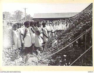 TOROKINA, BOUGAINVILLE. 1945-08-15. A GROUP OF SPECTATORS OUTSIDE THE CHAPEL, 2/1 GENERAL HOSPITAL, DURING THE MARRIAGE OF CORPORAL J.H. RICKARDS AND PRIVATE E.M. TOWNSEND