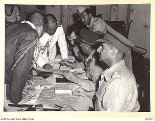 AT SEA OFF RABAUL, NEW BRITAIN. 1945-09-06. AUSTRALIAN AND JAPANESE STAFF OFFICERS IN CONFERENCE AFTER THE SURRENDER CEREMONY ABOARD THE AIRCRAFT CARRIER HMS GLORY. THE SURRENDER OF ALL JAPANESE ..