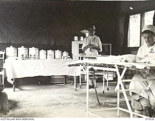 MADANG, NEW GUINEA. 1944-08-25. NURSING SISTERS WORKING IN THE TEMPORARY OPERATING THEATRE OF THE 2/11TH GENERAL HOSPITAL. THEY ARE:- VFX38559 SISTER J. LATTA (1); WFX3307 SISTER P.C. PHILLIPS (2)