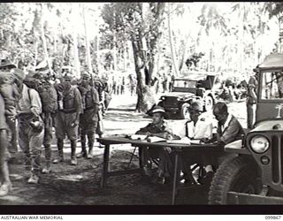 KOKOPO, NEW BRITAIN, 1946-02-28. JAPANESE TROOPS PASSING THROUGH 11 DIVISION CHECKING POINT BEFORE EMBARKING ON THE DEMILITARIZED AIRCRAFT CARRIER KATSURAGI FOR RETURN TO JAPAN