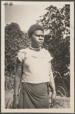 Papuan woman in blouse and loin cloth, New Britain Island, Papua New Guinea, approximately 1916