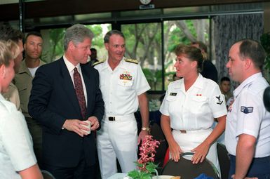 President William Jefferson Clinton and Adm. Charles R. Larson, commander-in-chief, Pacific Fleet, greet enlisted personnel during breakfast at the enlisted galley. The two are at Pearl Harbor as part of a tour of area military installations