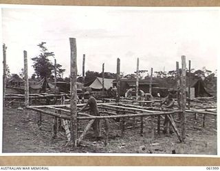 DREGER HARBOUR, NEW GUINEA. 1943-12-05. SLEEPING QUARTERS UNDER CONSTRUCTION OF THE 342ND UNITED STATES FIGHTER SQUADRON