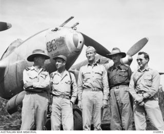 AITAPE, NORTH EAST NEW GUINEA. 1944-04-24. FIRST ALLIED PILOTS TO TRY OUT AIRSTRIP AT TADJI BUILT BY ENGINEERS OF NO. 62 WORKS WING RAAF GREETED BY AIR COMMODORE F. R. W. SCHERGER (EXTREME LEFT) ..