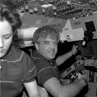 STS-49 Thornton and Brandenstein work on the flight deck of OV-105