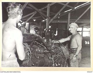 PURUATA ISLAND, SOUTH BOUGAINVILLE. 1945-05-29. CORPORAL H.P. SMYTH, 42 LANDING CRAFT COMPANY, RUNNING IN A BARGE ENGINE IN THE WORKSHOPS. THIS COMPANY HAS PLAYED AN IMPORTANT PART IN SUPPLYING ..