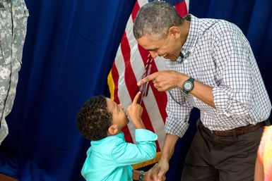 President Barack Obama and a Young Boy Pointing at Each Other