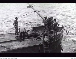 MILNE BAY, NEW GUINEA. 1943-06-29. "C" GROUP, 2/3RD AUSTRALIAN DOCKS OPERATING COMPANY, ROYAL AUSTRALIAN ENGINEERS, CONDUCTING SALVAGE OPERATIONS ON THE "ANSHUN". THIS VESSEL WAS SUNK BY JAPANESE ..